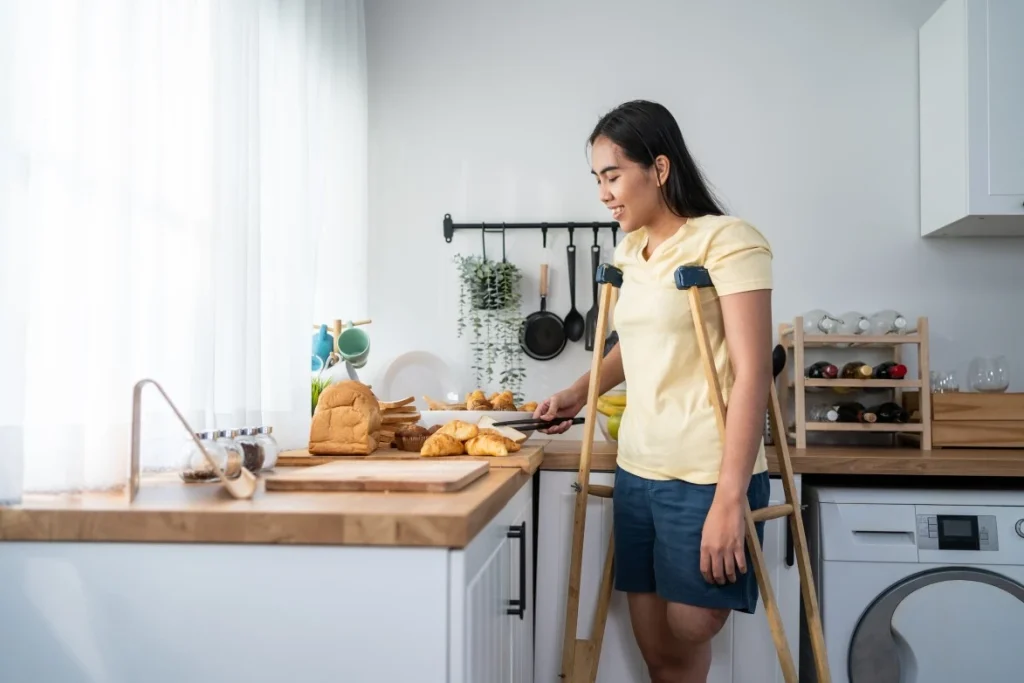 A disabled woman cooking in the kitchen